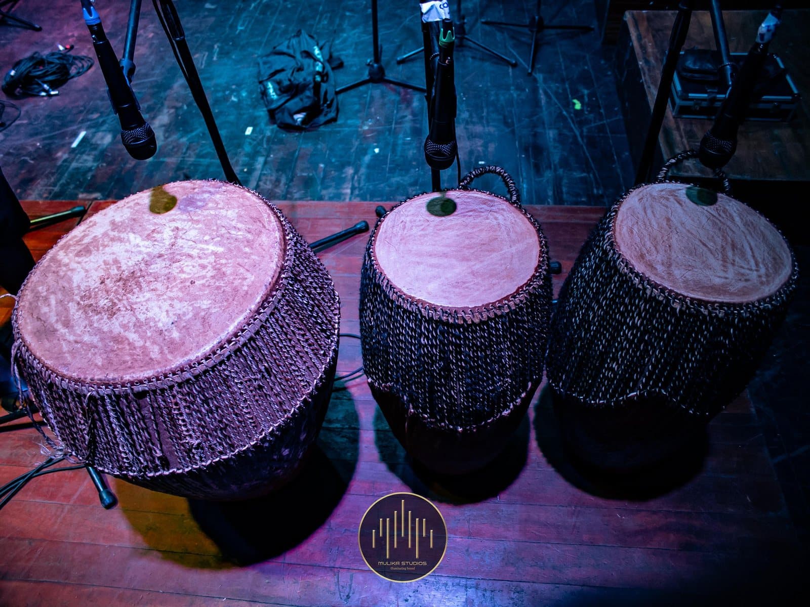 Three engoma drums close-miked on stage at the Uganda National Cultural Centre